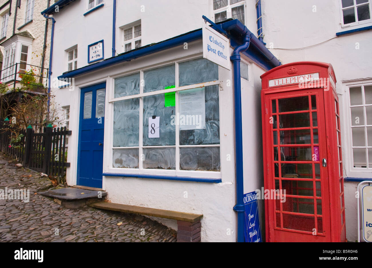 Closed Post Office in the coastal village of Clovelly North Devon England UK next to red telephone box Stock Photo