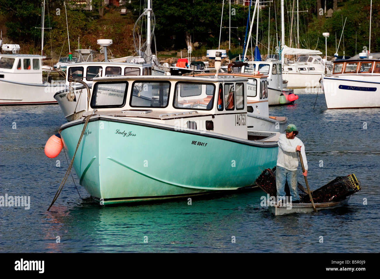 Lobster fisherman rows his traps out to a boat in Perkins Cove, Maine