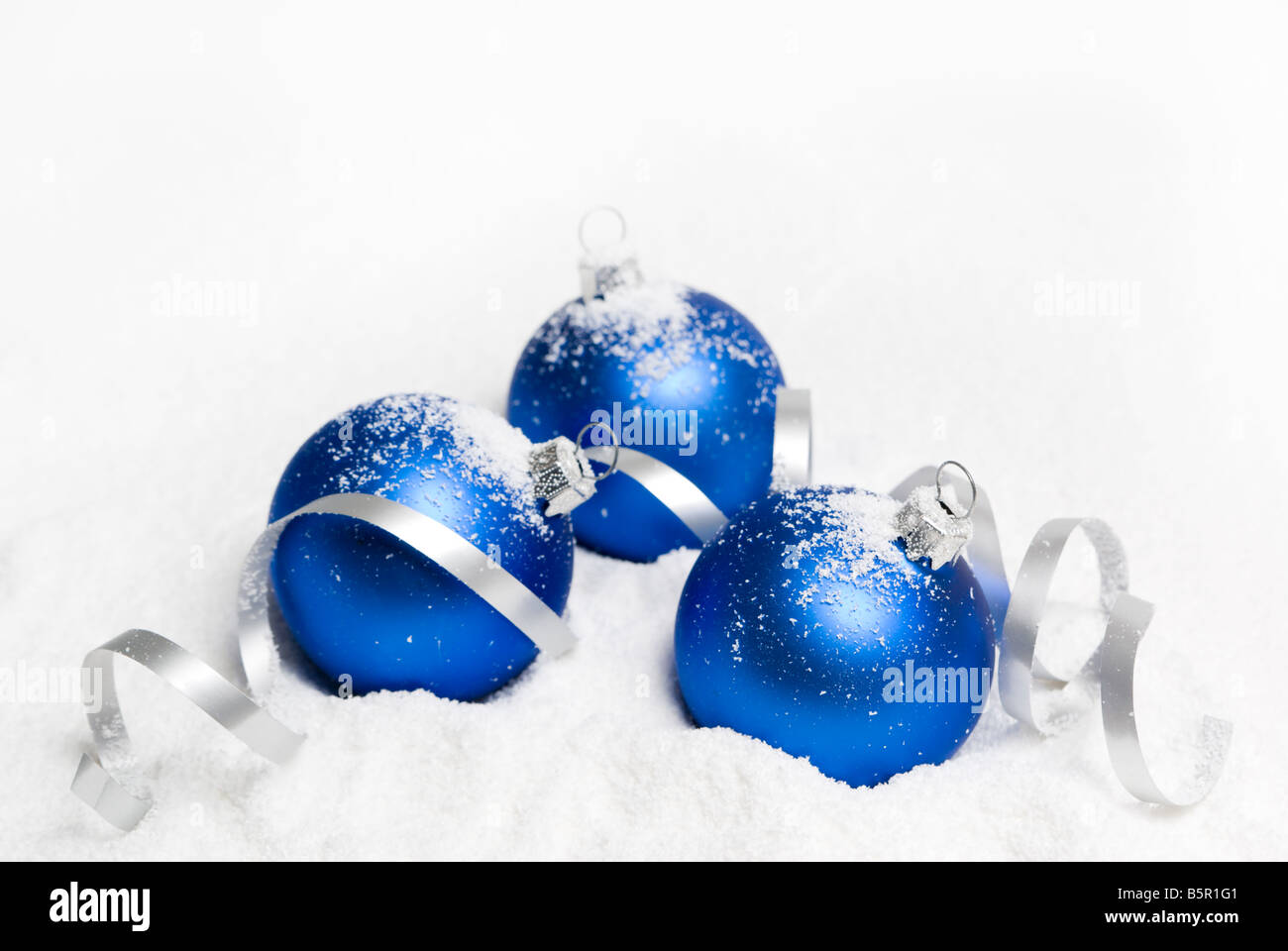 Blue christmas balls lying on the snow. aRGB. Stock Photo