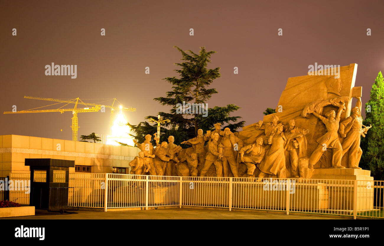Mao Statue in front Mao Zedong Tse Tung Tomb Tiananmen Square Beijing China Night Shot Yellow Building Crane in Background Stock Photo