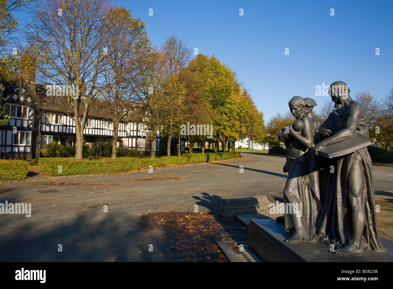 "Industry Charity and Education" statues outside workers houses in Port