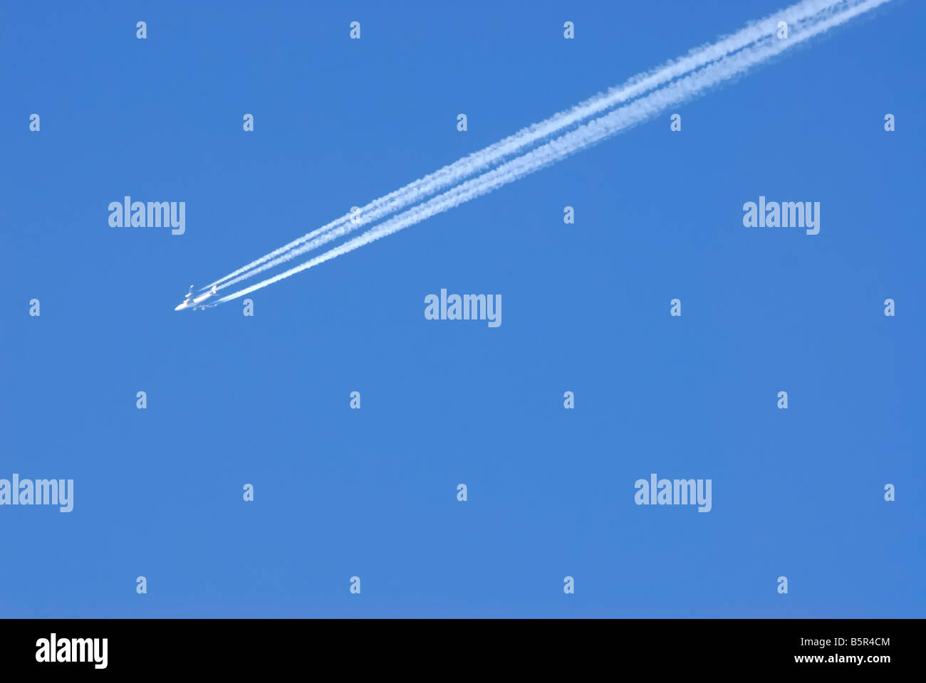 An airplane in the blue sky Stock Photo - Alamy
