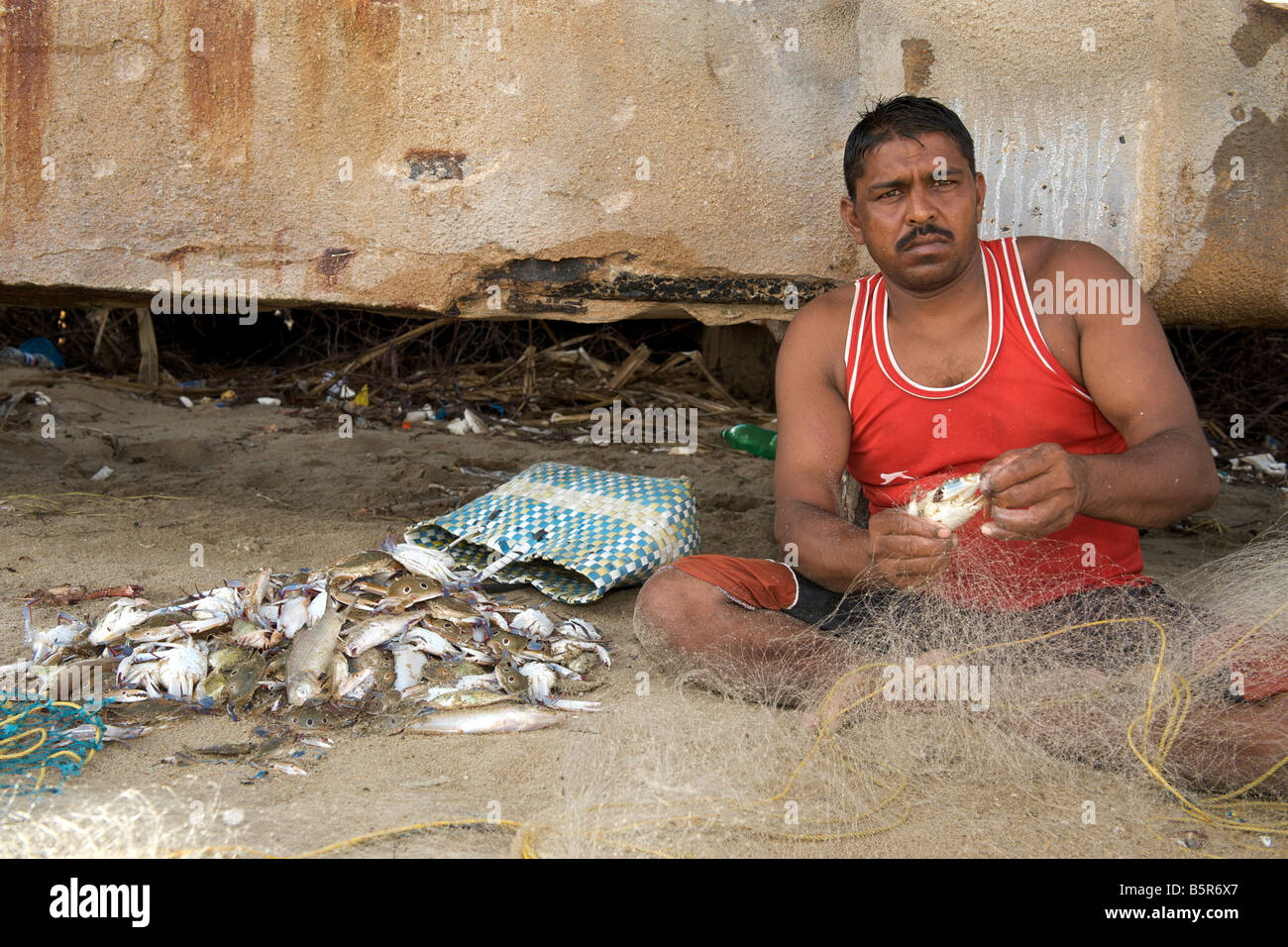 Indian fishermen sorting his catch in Pondicherry India. Stock Photo