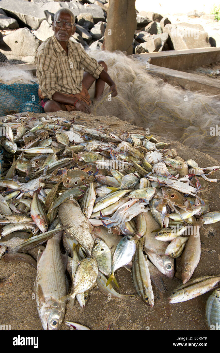 Indian fisherman under the pier in Pondicherry India. Stock Photo