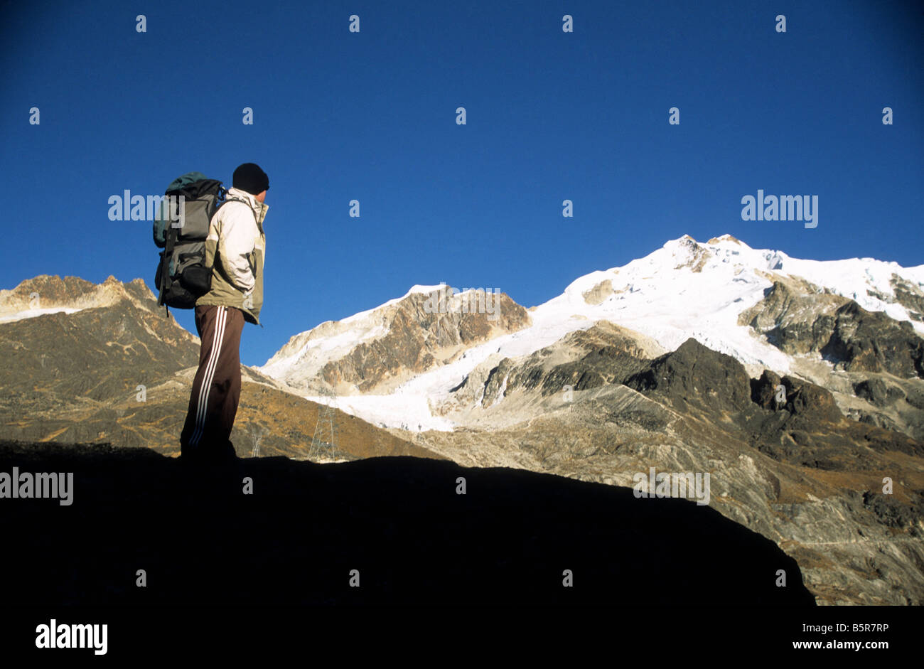 Trekker looking at view to Mount Huayna Potosi from Abra Zongo / Zongo Pass, Cordillera Real, Bolivia Stock Photo