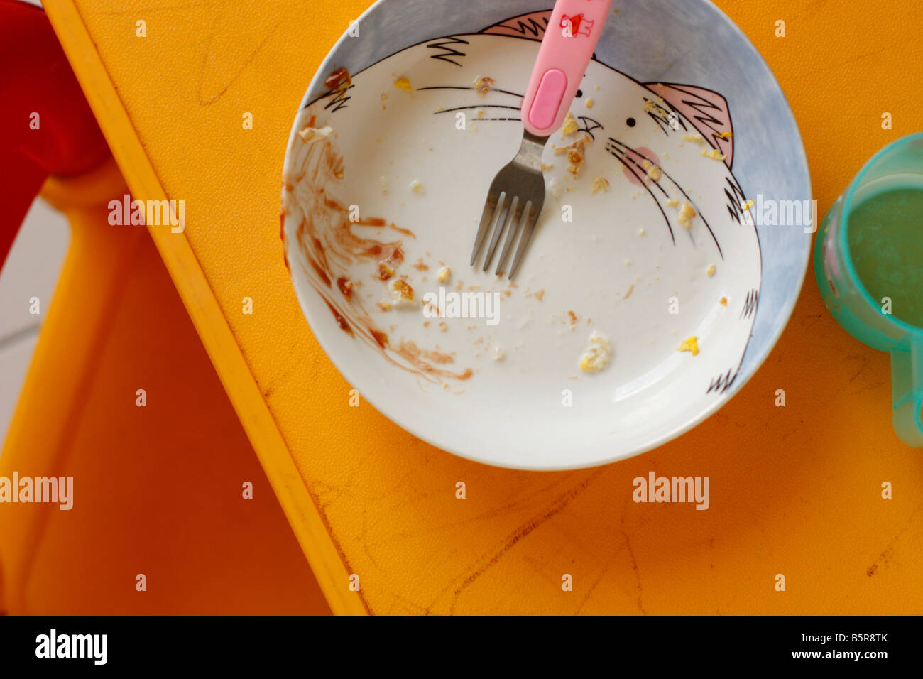 Dirty plate on a child's table. Stock Photo
