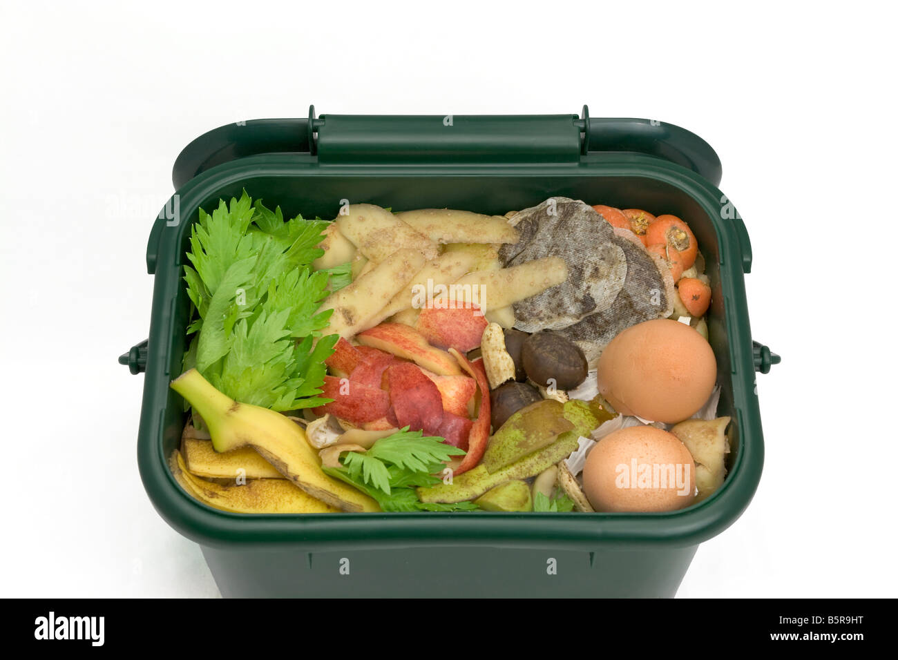 Food waste for composting in domestic recycling waste bin Stock Photo
