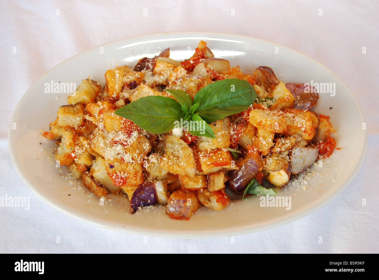 a plate of egg-plant with Parmesan tomato and basil Stock Photo