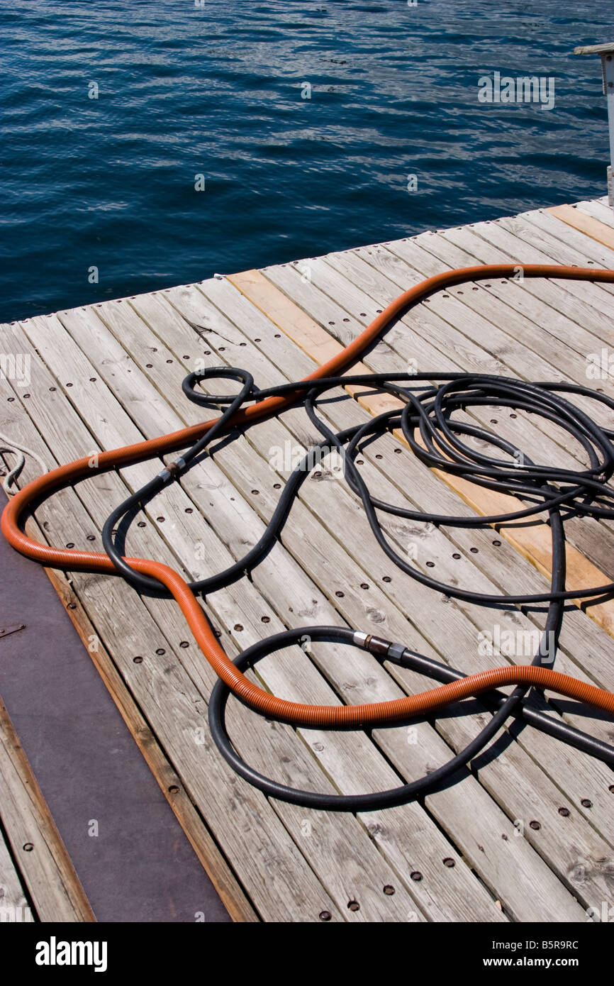Hoses laying on a wooden dock Stock Photo
