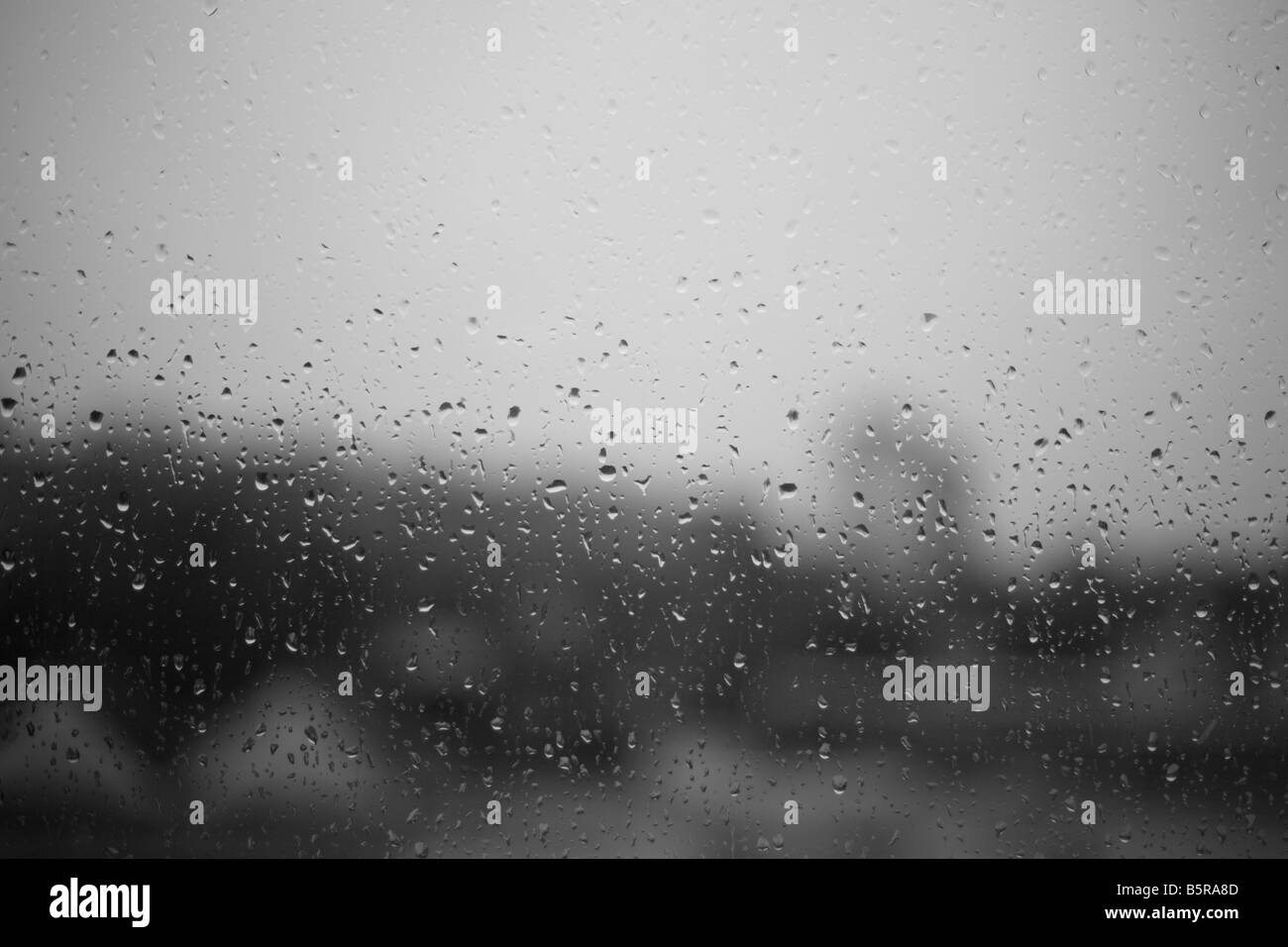 Rain water runs down a window on a gloomy rainy day Stock Photo Alamy