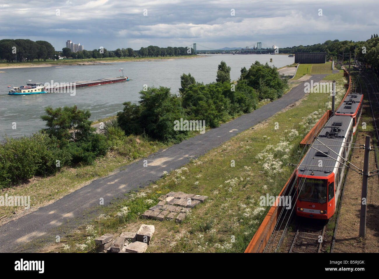 Tram running on tracks beside the river Rhine, Cologne, North Rhine-Westphalia, Germany. Stock Photo