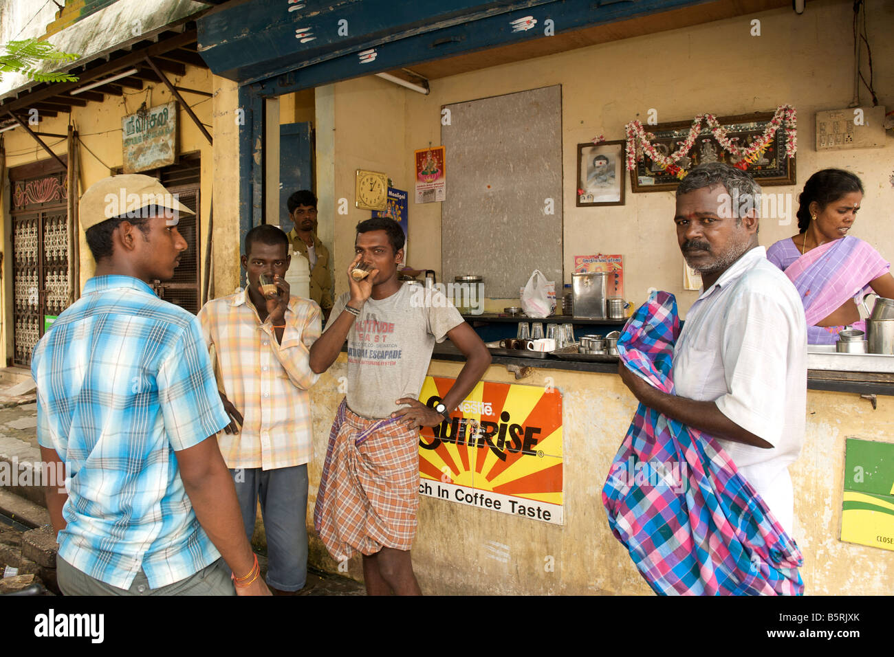 Indians drinking coffee at a corner coffee bar in Pondicherry India. Stock Photo