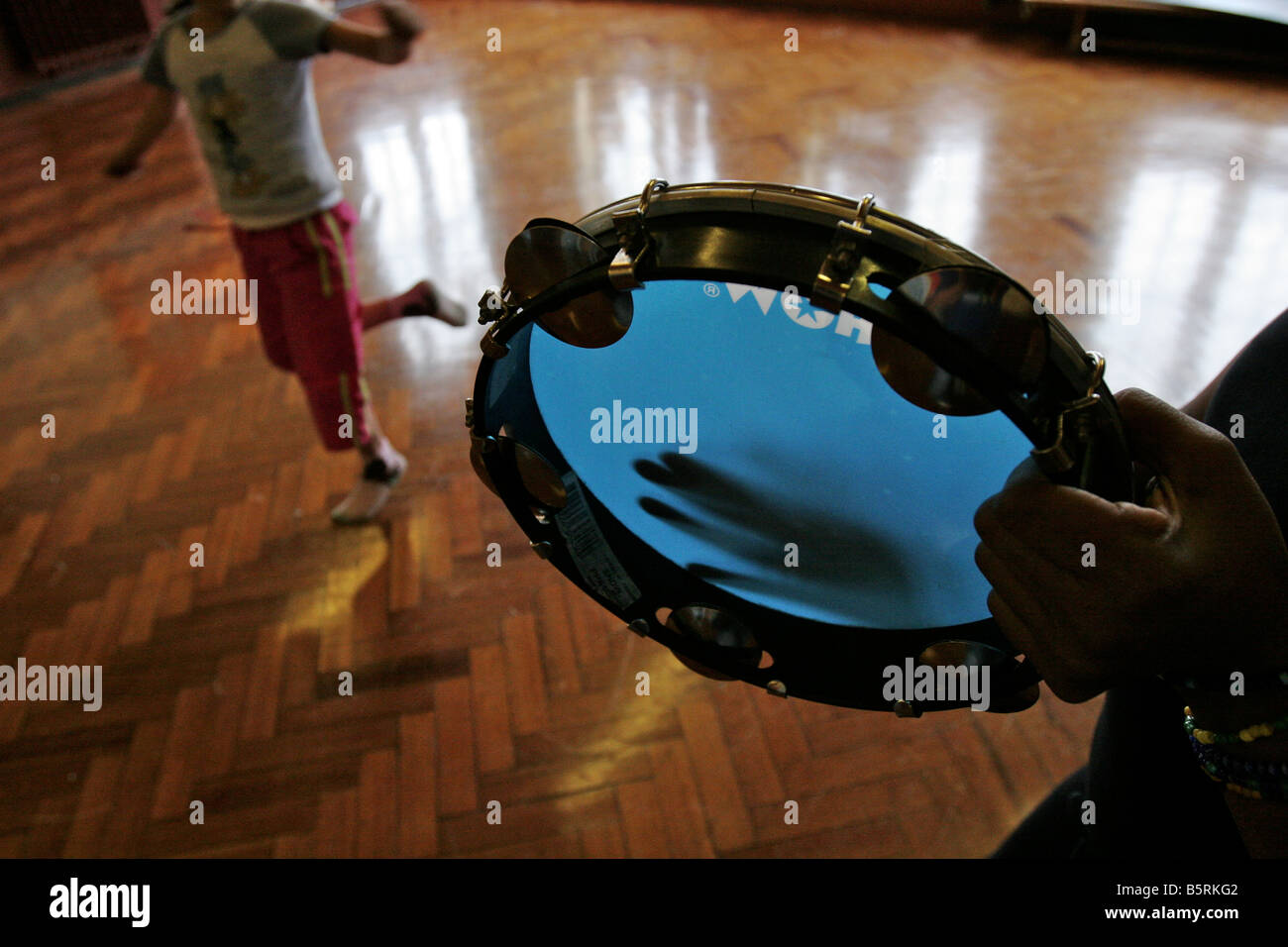 child dancing to a tambourine Stock Photo Alamy
