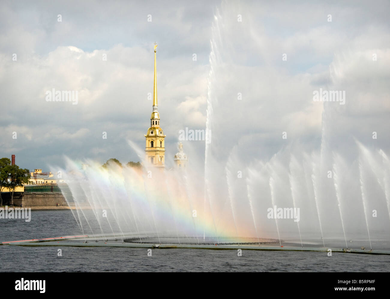 Rainbow in the dancing fountains on river Neva with Peter and Paul Cathedral in the background, Saint Petersburg, Russia Stock Photo