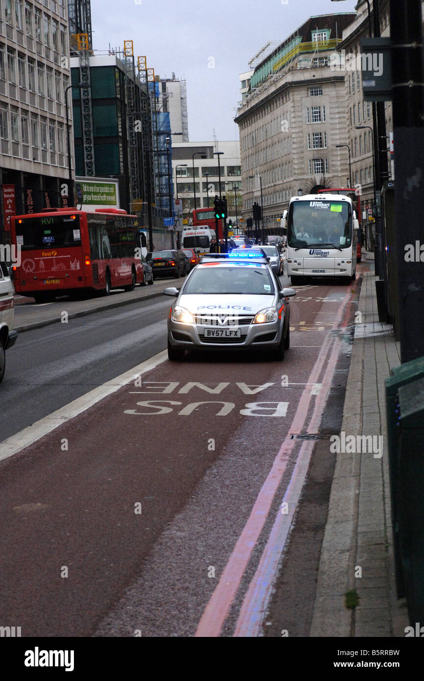 Police car speeding in a bus lane in London during an emergency Stock