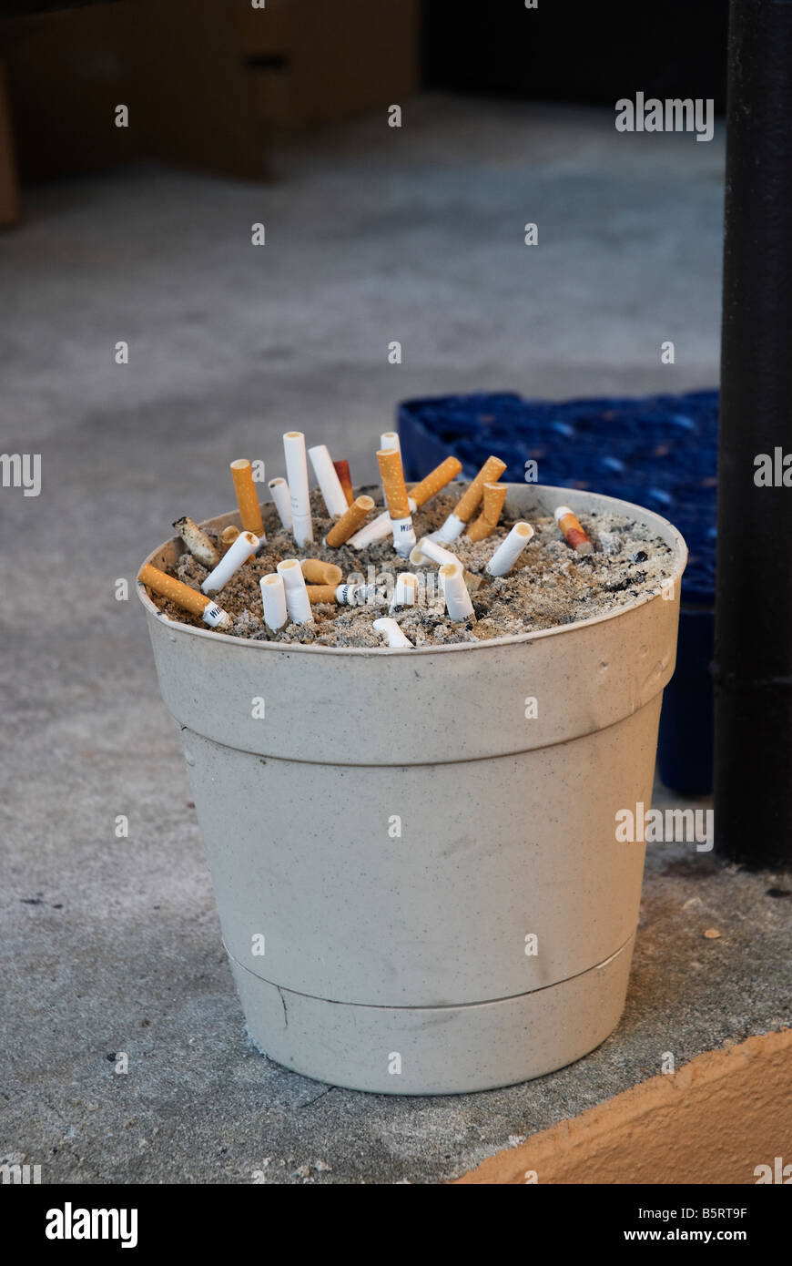 cigarette butts in pot of sand in smoking area outside VA hospital Lake