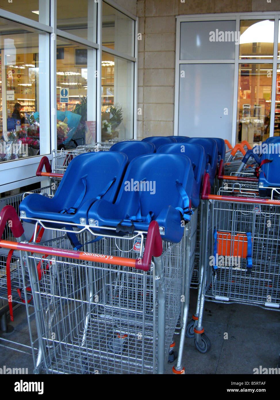 Shopping carts with baby seats attached Stock Photo Alamy