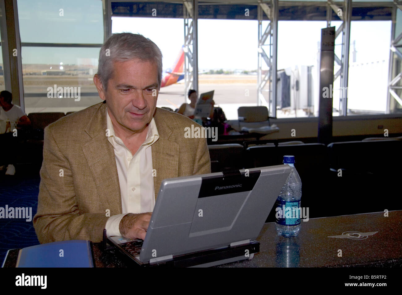 Man using a laptop computer in the Boise Airport Boise Idaho Stock Photo