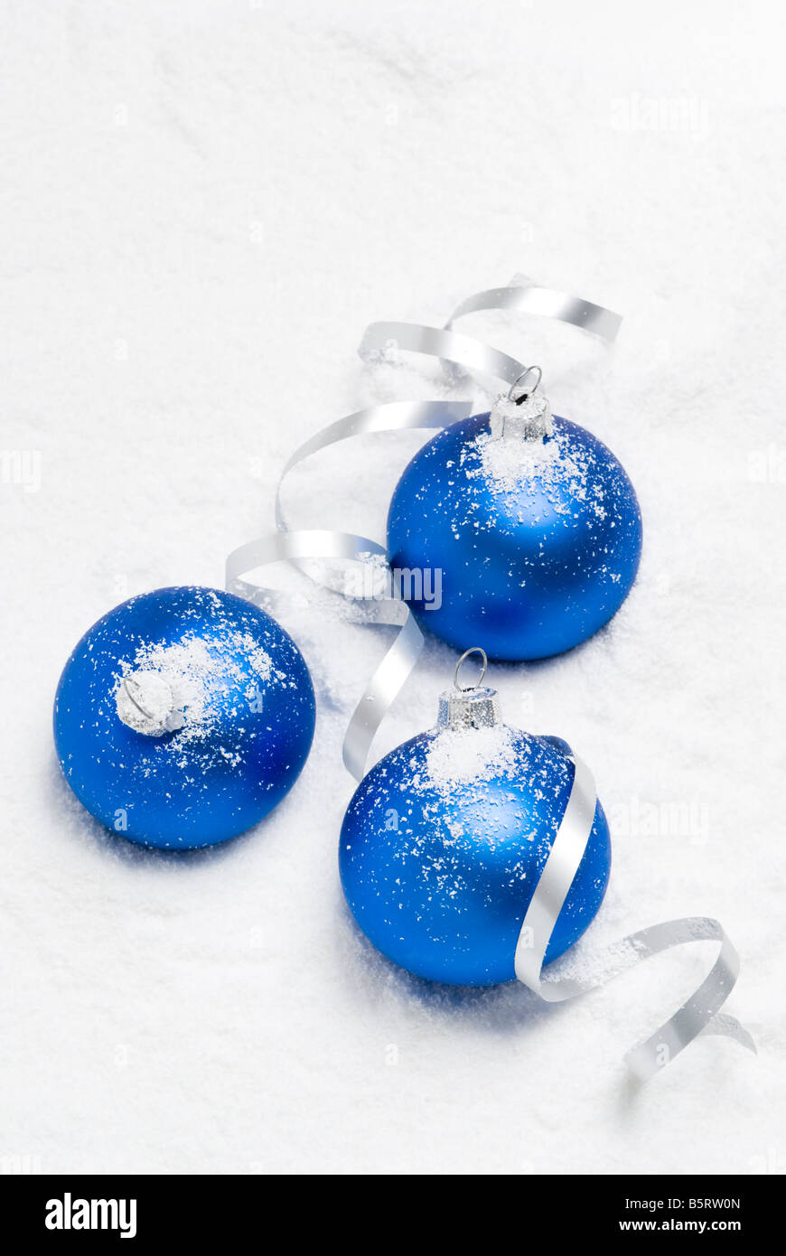 Blue christmas balls lying on the snow. aRGB. Stock Photo