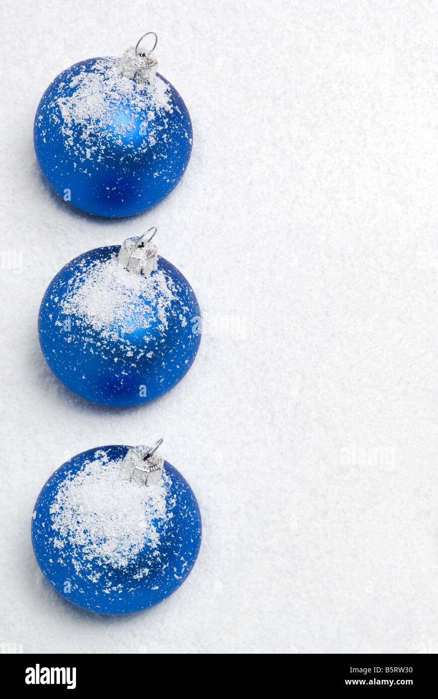 Blue christmas balls lying on the snow. aRGB. Stock Photo