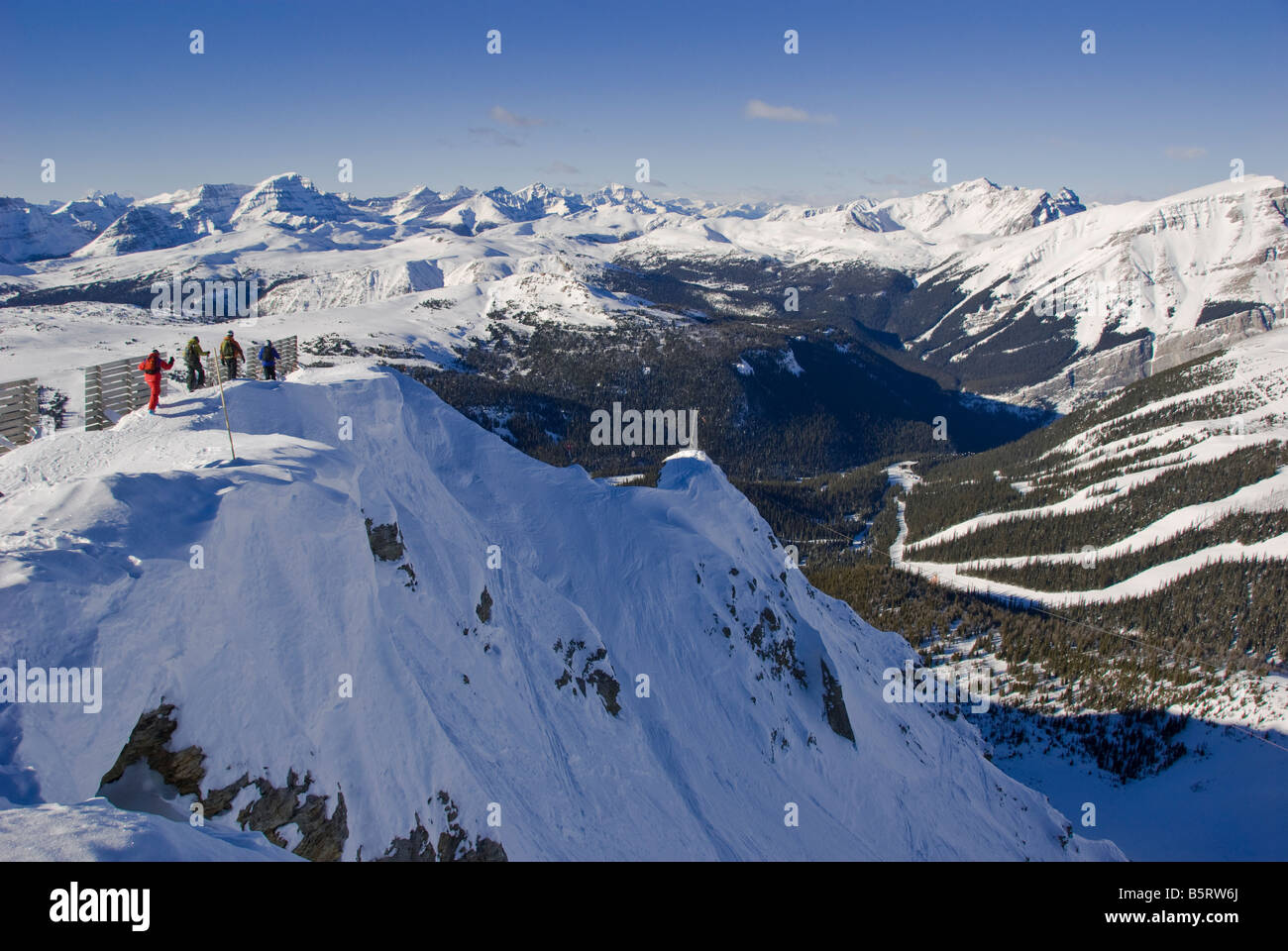 Skiers walk along the edge of Delirium Dive, Sunshine Village Ski