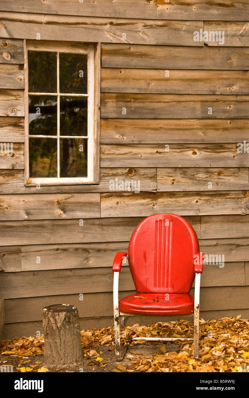 Red chair in front of rural building Stock Photo Alamy