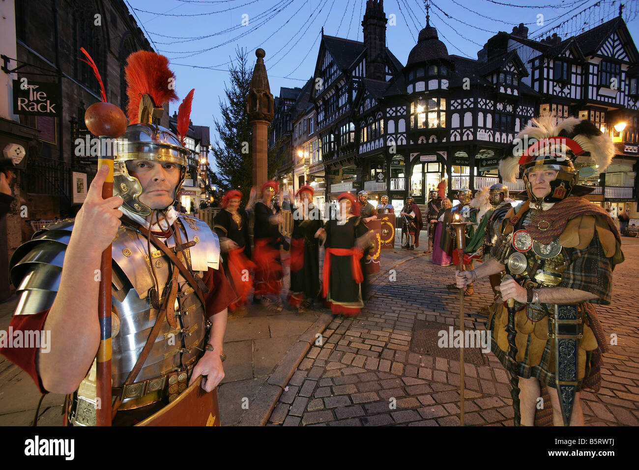 City of Chester, England. Roman Tours conducting a torchlight Christmas parade Saturnalia re-enactment event in the city centre. Stock Photo