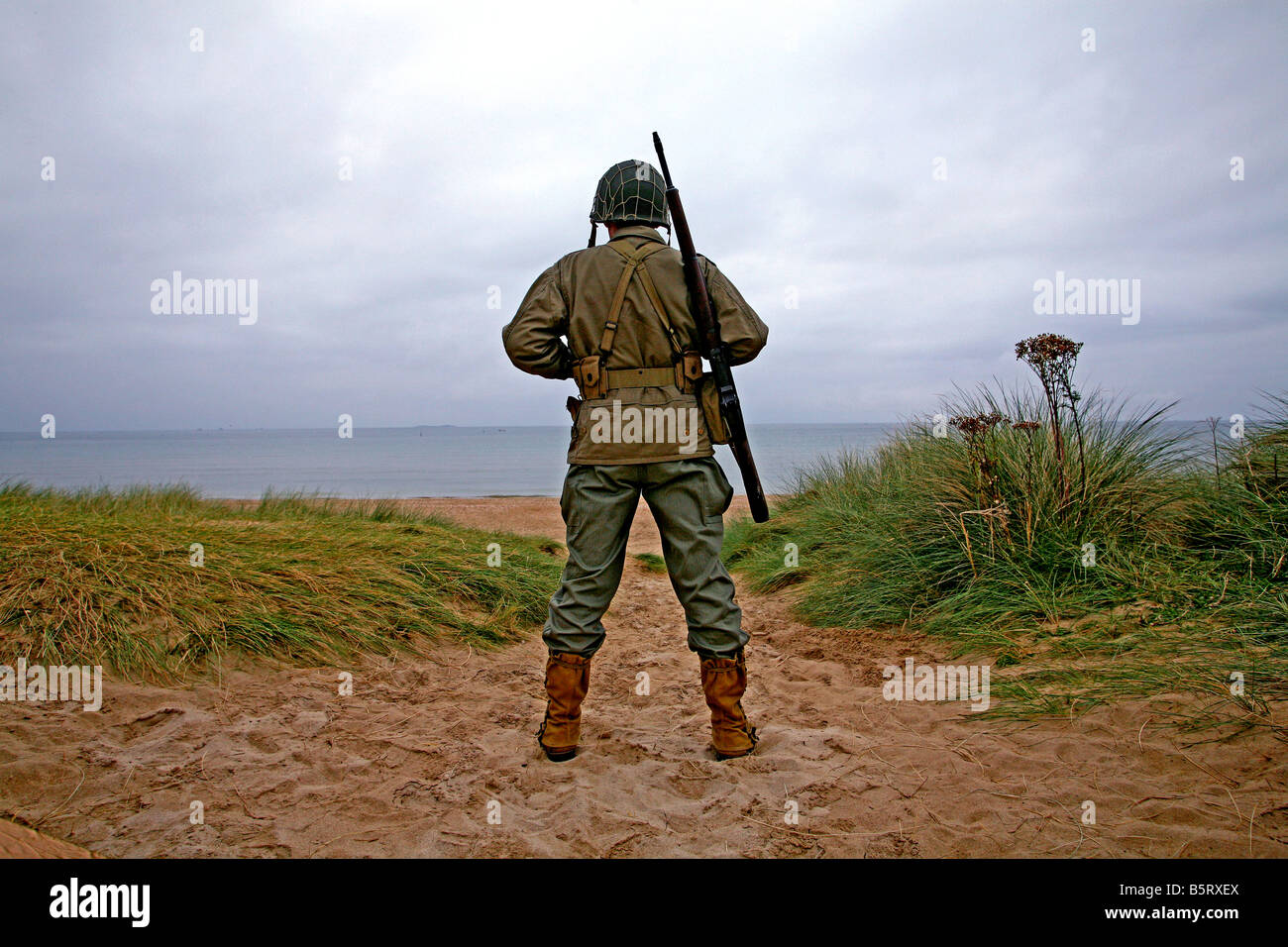 An actor dressed as an D-Day  American soldier looking out on  Utah Beach (the allied invasion of) Normandy ,France Stock Photo