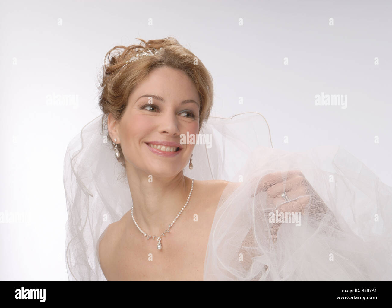 Mid adult woman in bridal veil smiling, portrait Stock Photo - Alamy