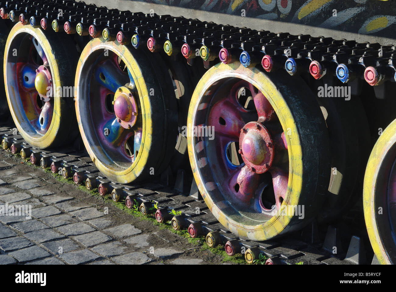 Caterpillar of old war tank painted with bright dyes, powerful details Stock Photo
