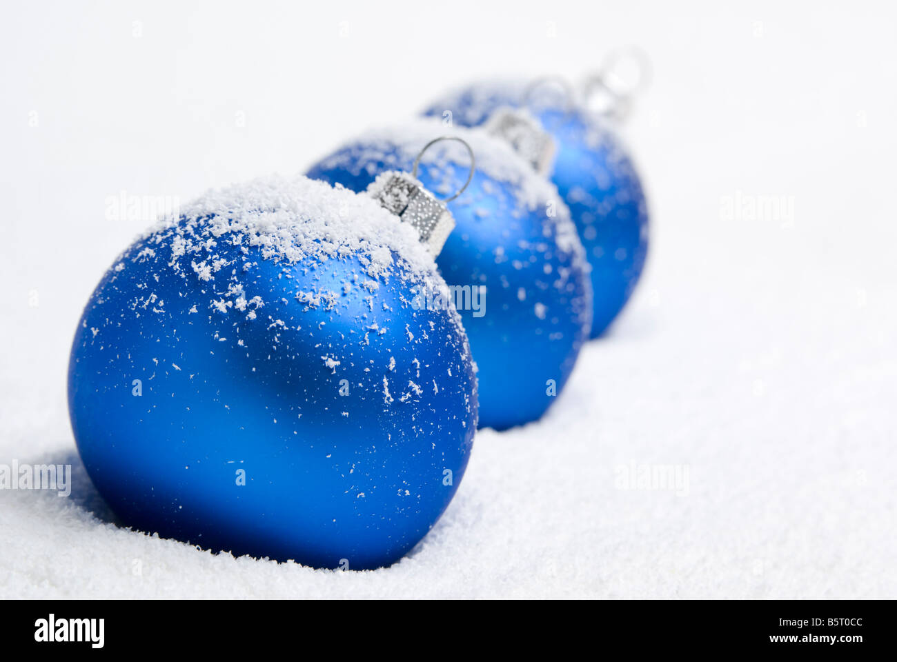 Blue christmas balls lying on the snow. aRGB. Stock Photo