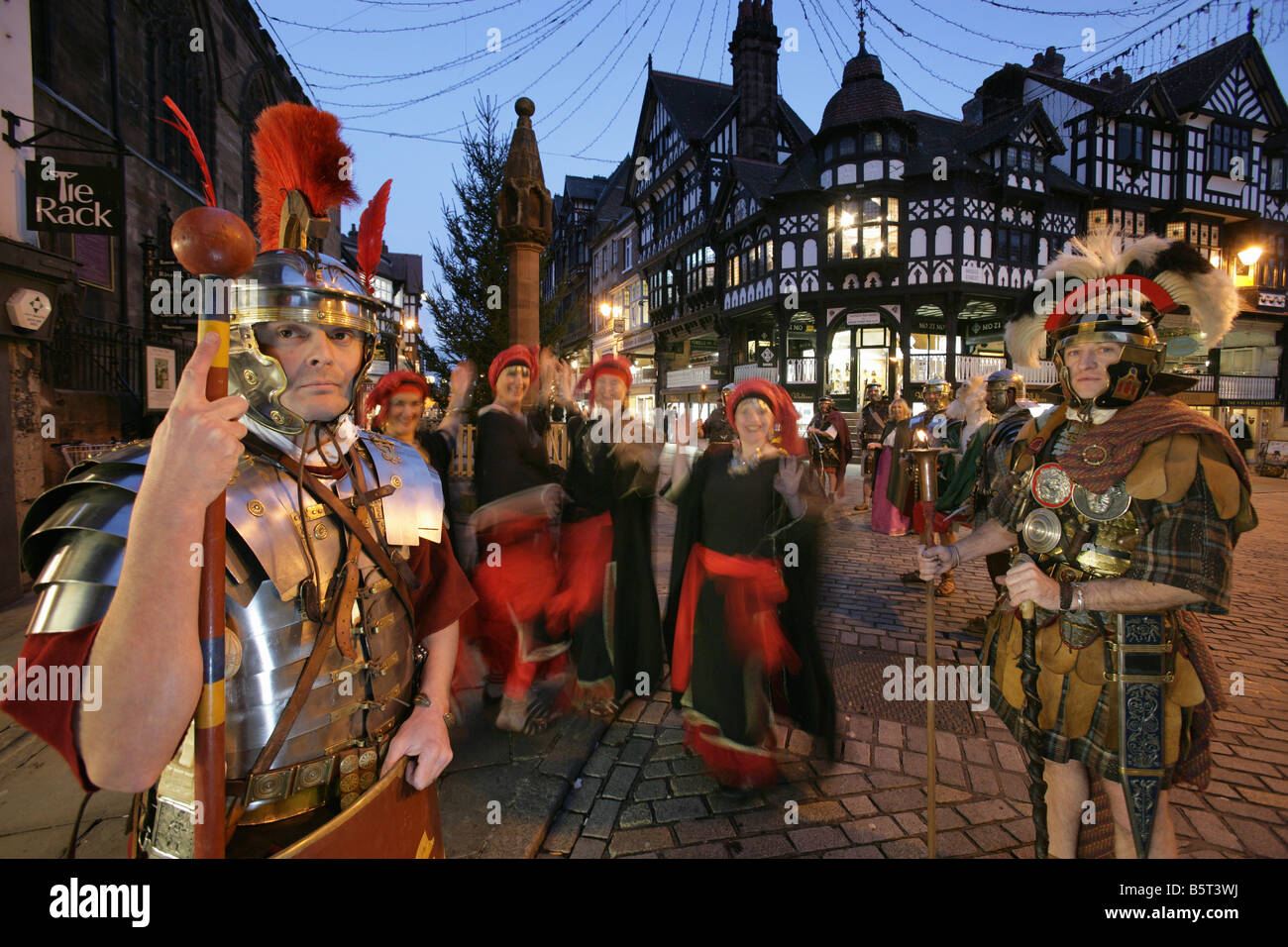 City of Chester, England. Roman Tours conducting a torchlight Christmas parade Saturnalia re-enactment event in the city centre. Stock Photo