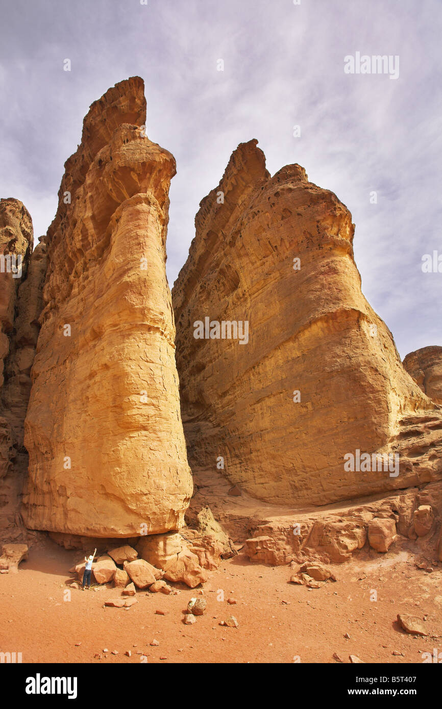 The tourist at bottom huge rocks of the freakish form in Park Timna in Israel Stock Photo
