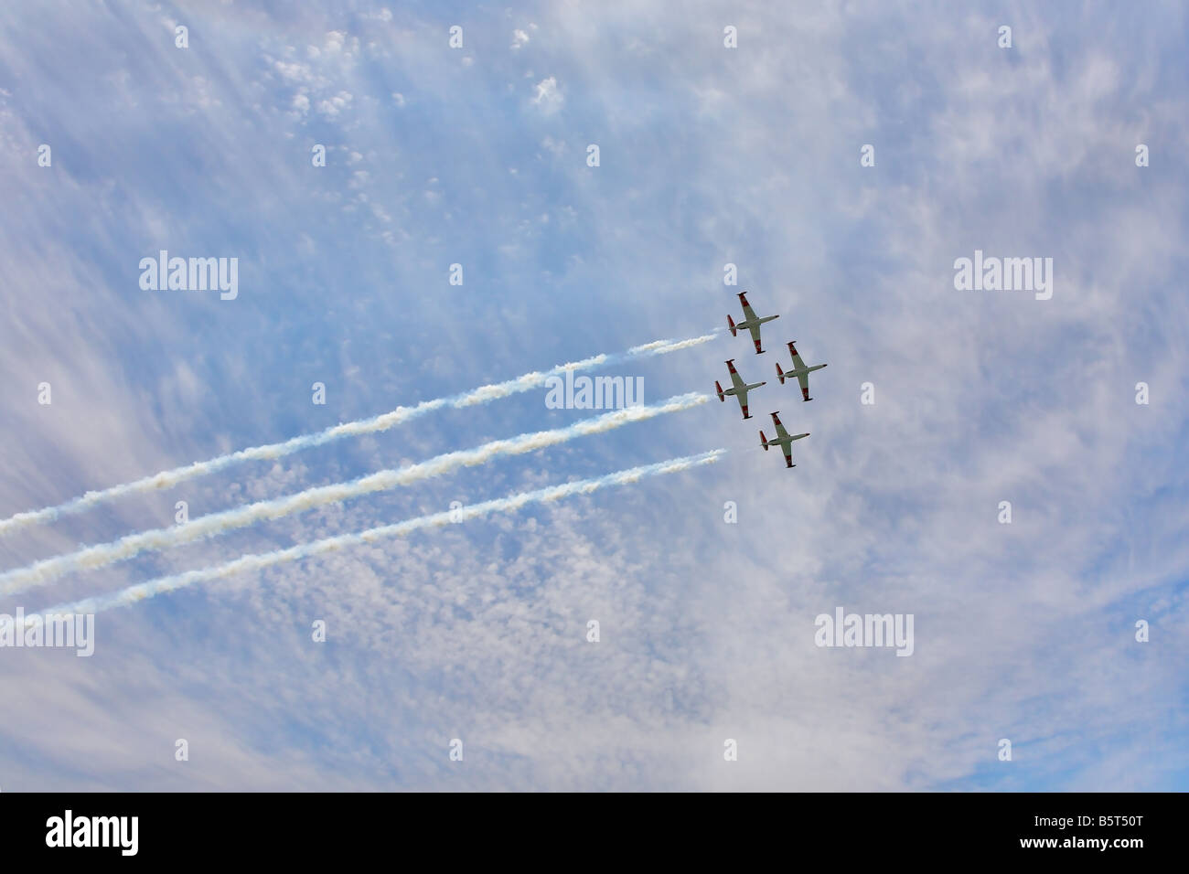 Four magnificent planes on air parade show art of synchronous flight Stock Photo