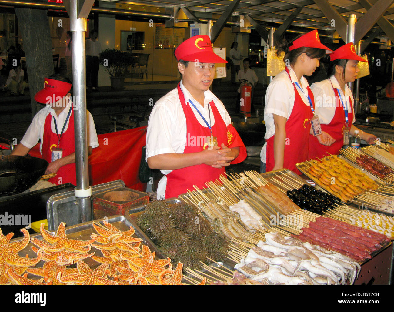 Workers on the Donghuamen Night food street Market in Beijing China Stock Photo