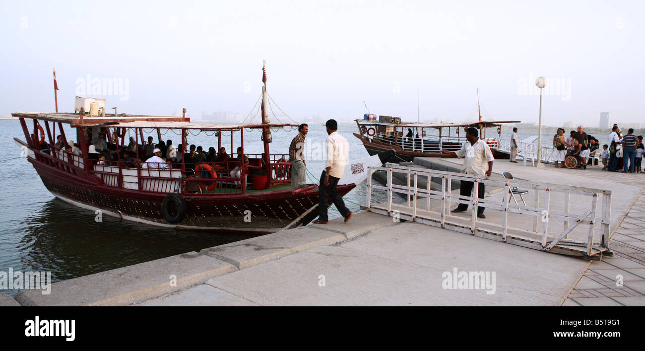Holidaymakers boarding pleasure trip dhows on Doha Corniche Qatar Arabia during Eid holidays October 2 2008 Stock Photo