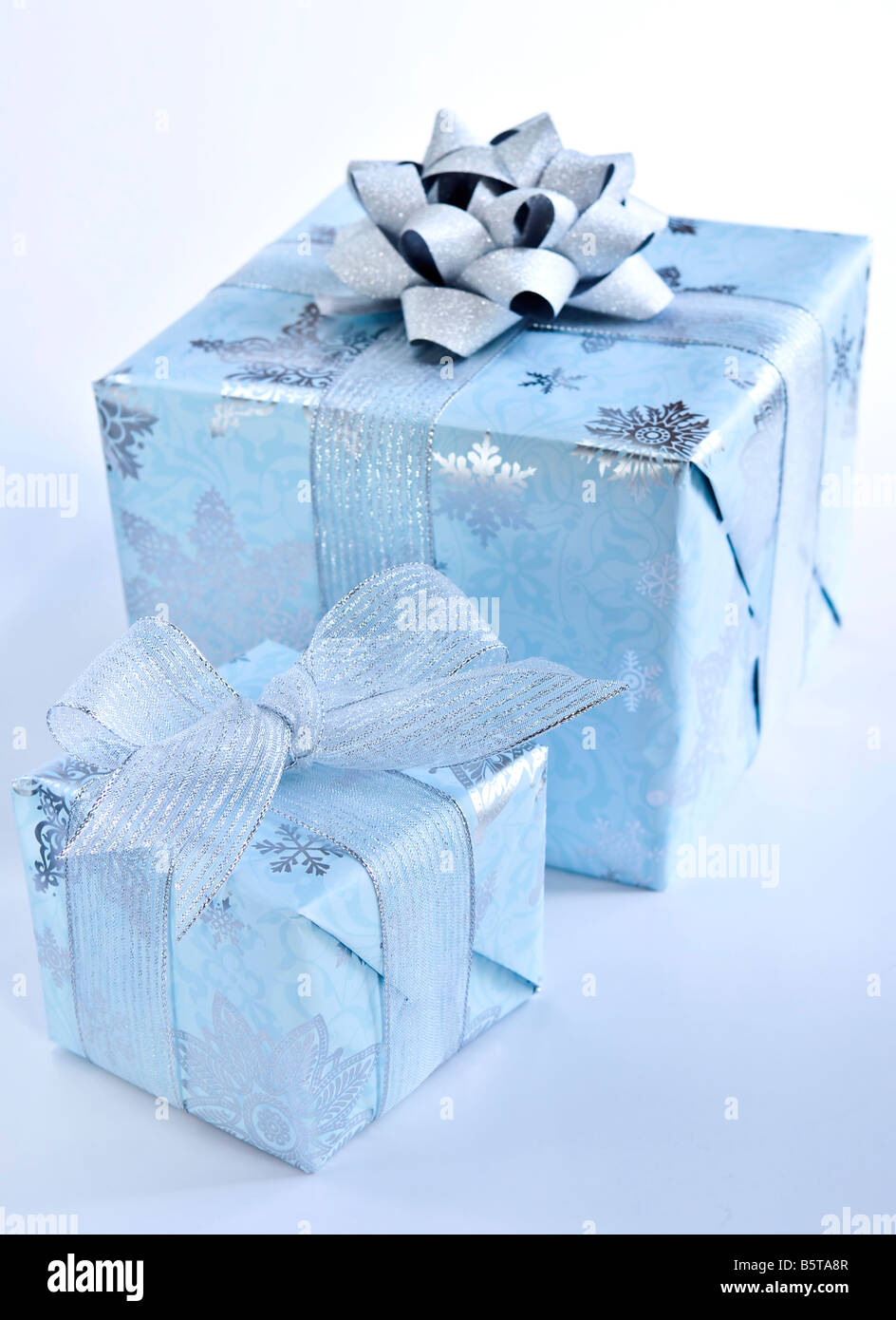 Two christmas gift boxes wrapped in blue paper with silver ribbon Stock ...