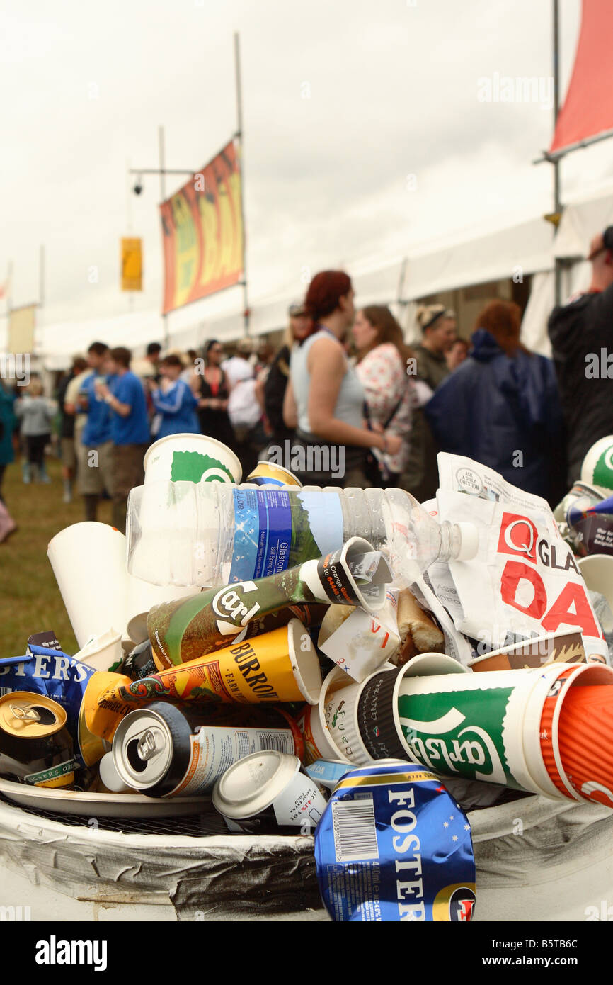 Waste empty rubbish beer cans overflowing from a litter bin at a outdoor music festival Stock Photo