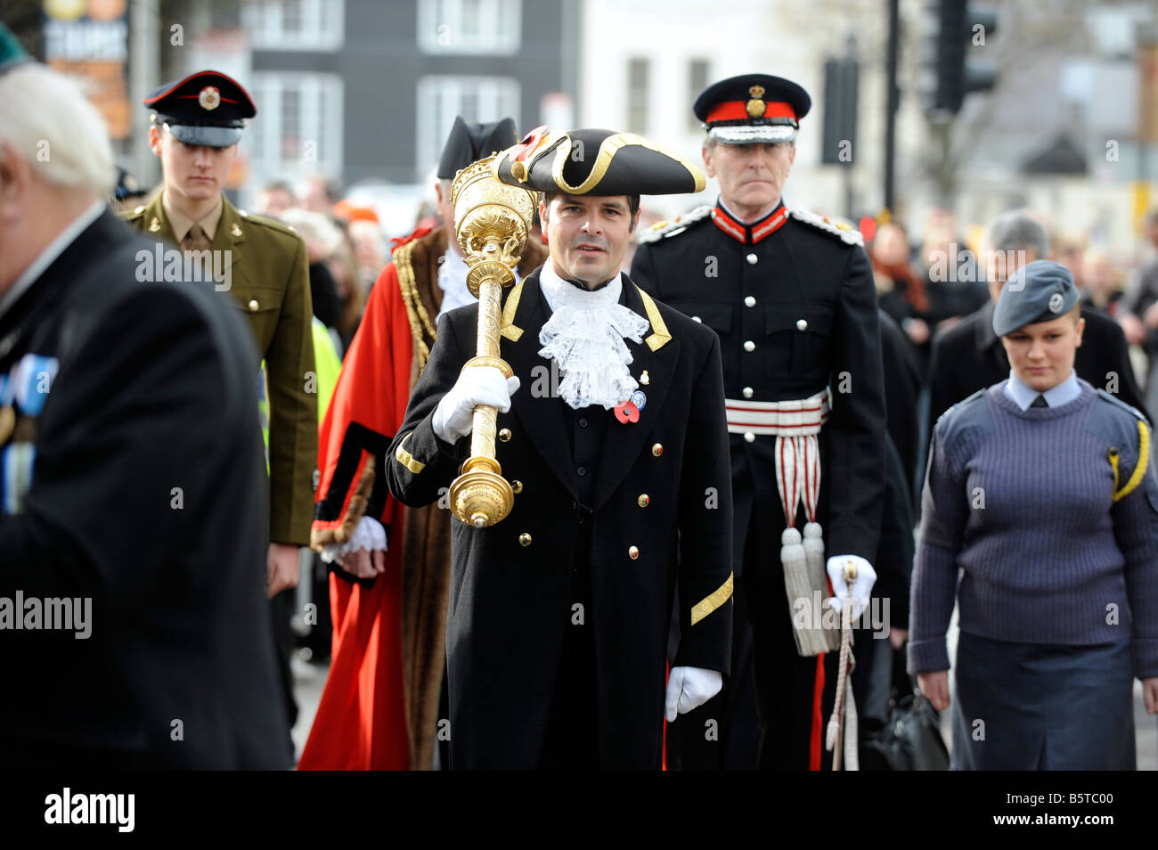The mace bearer leads in the Mayor to the Act of Remembrance Service in