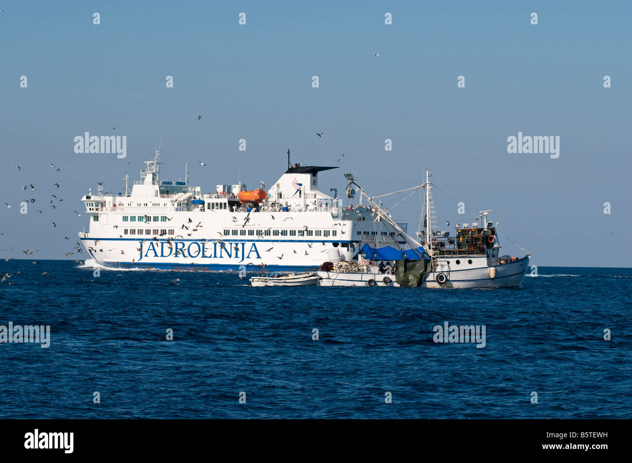 Ferry and fishing boat in Adriatic Croatia. Stock Photo