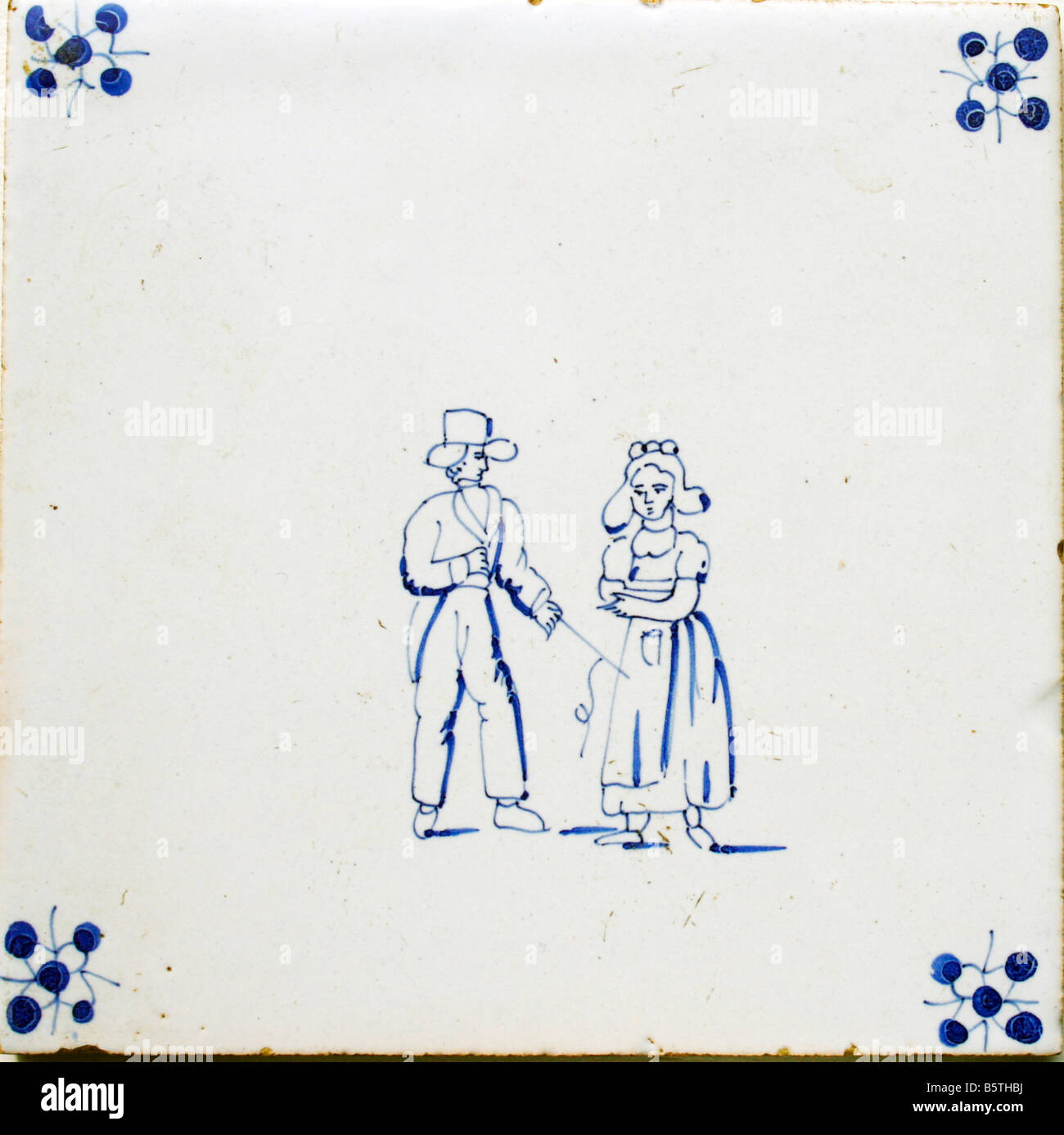 Original antique Dutch 17th century Delft blue tile with couple Stock Photo