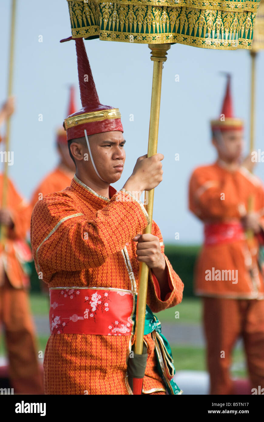Bearer of a Tiered Gold embroidered Umbrella in traditional uniform