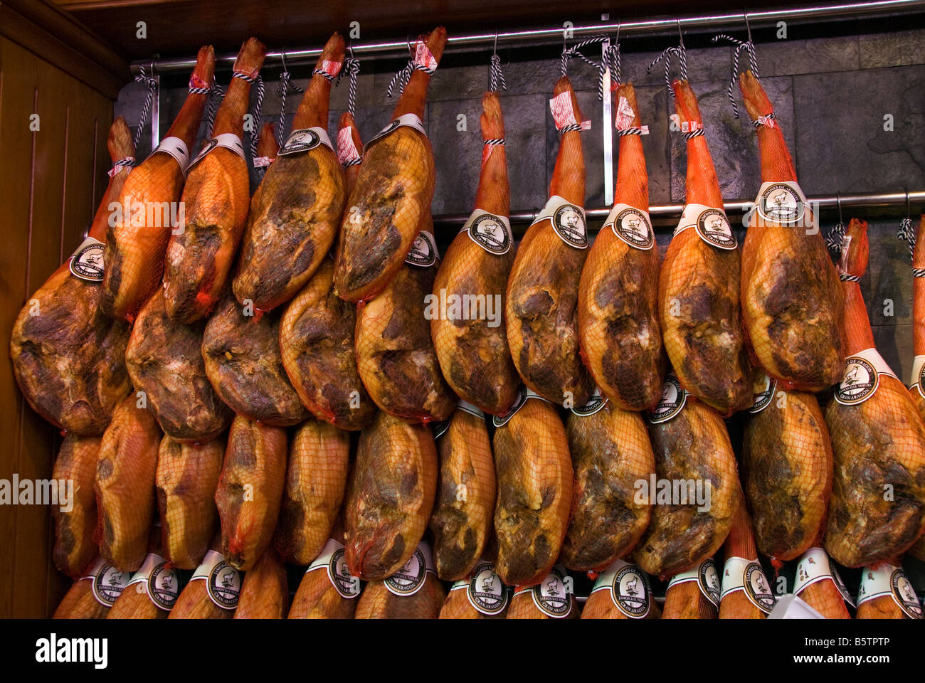 Spanish hams Jamones at a meat stall in the central market Mercado Central in the historical city centre of Valencia Spain Stock Photo