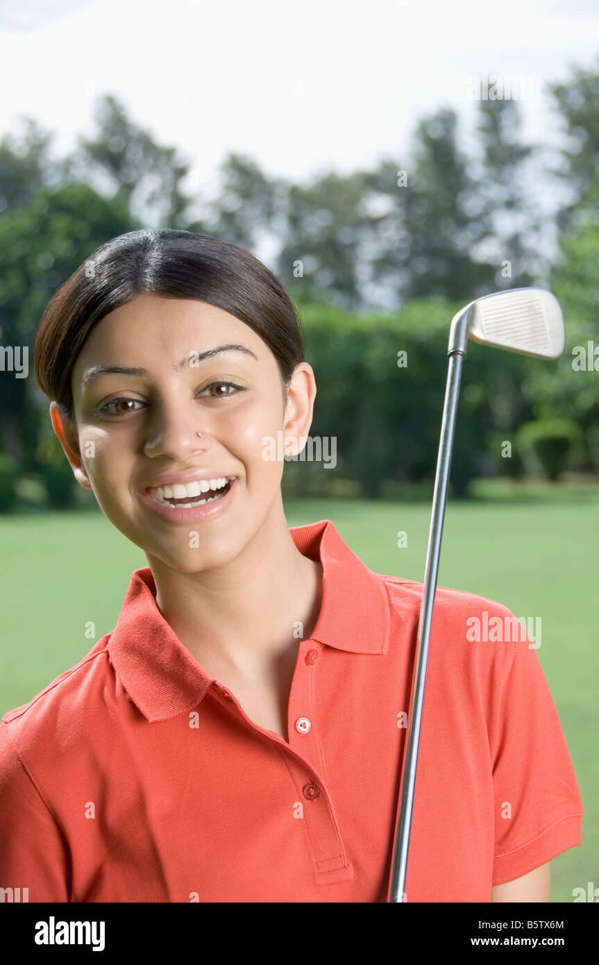 Woman with a golf club in a golf course Stock Photo Alamy