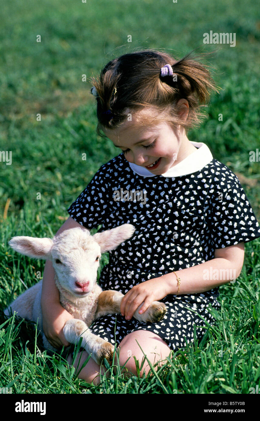 Little girl holding a small lamb Stock Photo