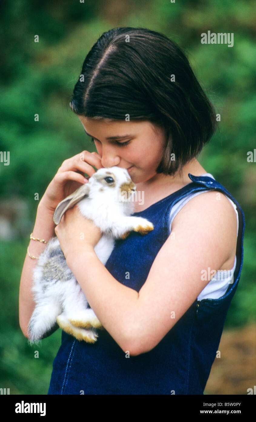 Young girl cuddling a rabbit Stock Photo