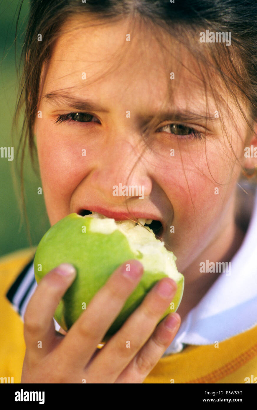 Young girl child eating an apple Stock Photo