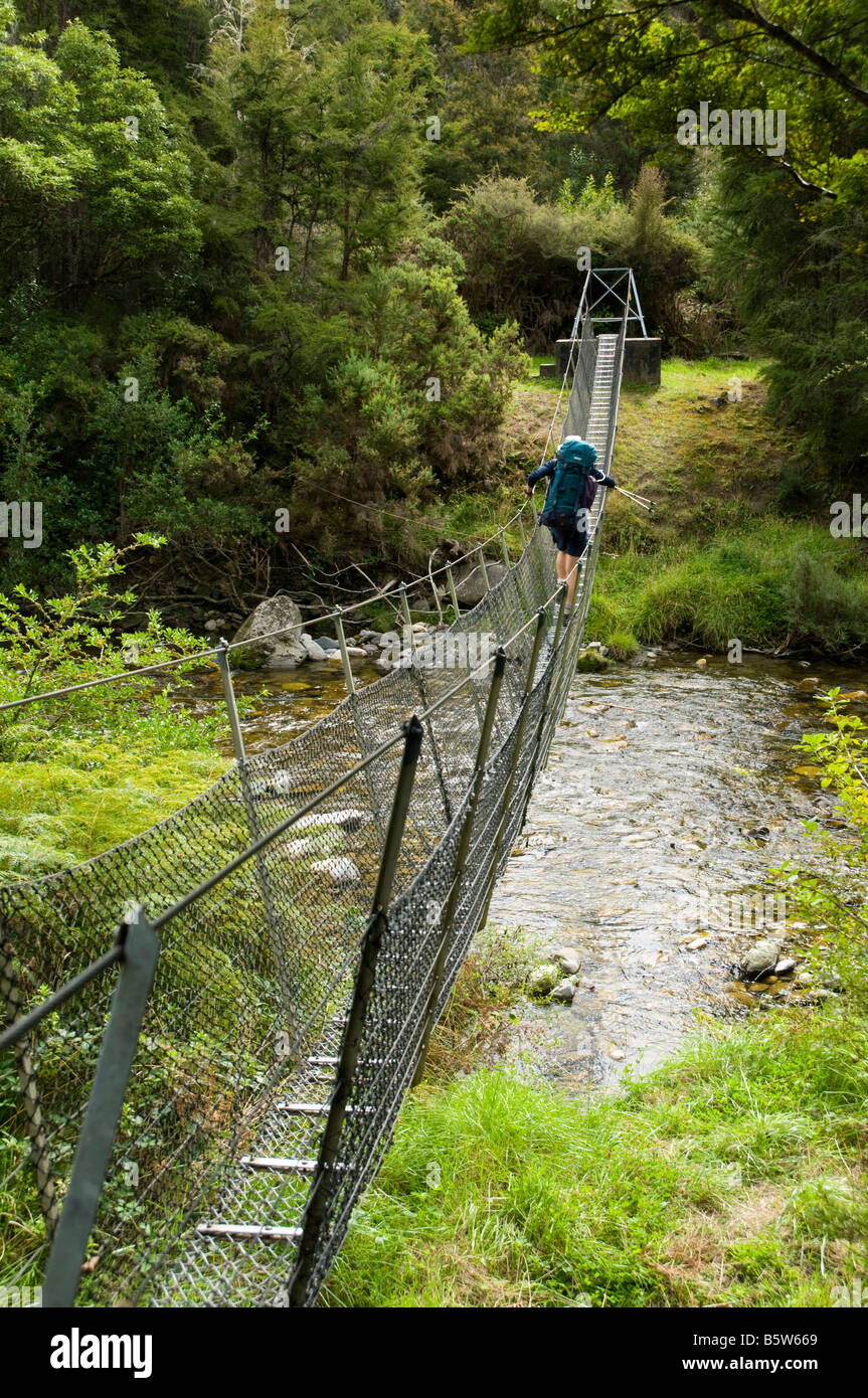 Crossing a swing suspension bridge, Wangapeka Track, South Island, New