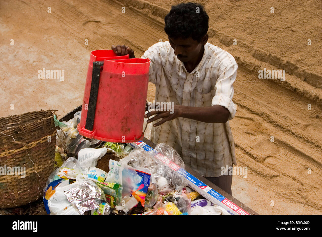 Garbageman collecting garbage from houses in Chennai, Tamil Nadu, India