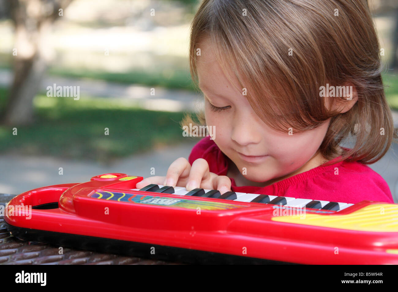 child playing music on a small keyboard Stock Photo